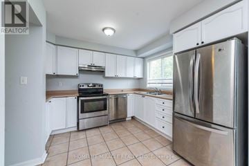 Brampton (Fletcher's Meadow) apartment for rent - A kitchen with white cabinets and a stainless steel refrigerator.