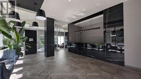 Toronto (Weston) condo for rent - A modern office lobby with a large glass wall and a reception desk.