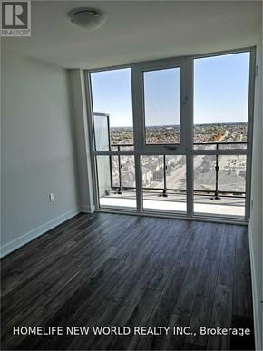 Richmond Hill (Langstaff) condo for rent - A room with a view of a cityscape through large windows.
