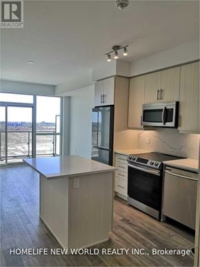 Richmond Hill (Langstaff) condo for rent - A kitchen with a stove top oven and microwave.
