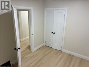 Hamilton apartment for rent - A white door with a black handle is in a room with wood flooring.