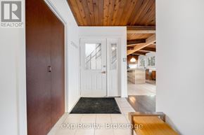 Parry Sound apartment for rent - A hallway with a white door and a wooden ceiling.