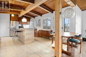 Parry Sound apartment for rent - A kitchen with a wooden ceiling and a dining table with chairs.