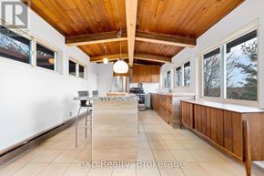 Parry Sound apartment for rent - A kitchen with wooden cabinets and a tiled floor.
