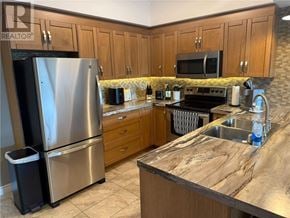 Sudbury apartment for rent - A kitchen with a granite counter top and stainless steel appliances.