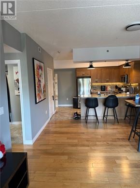 Sudbury apartment for rent - A kitchen with a bar stool and a fridge.