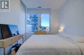 Mississauga (City Centre) condo for rent - A spacious kitchen with wooden flooring and white walls.