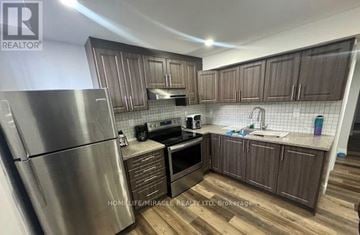 Brampton (Fletcher's Meadow) apartment for rent - A kitchen with wooden cabinets and a stainless steel refrigerator.