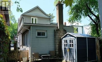 Toronto (Woodbine-Lumsden) apartment for rent - A house with a grey exterior and a small shed in front.