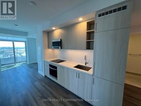 Vaughan (Vaughan Corporate Centre) condo for rent - A modern kitchen with wooden cabinets and a sink.