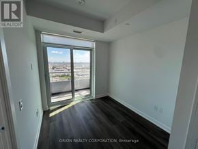 Vaughan (Vaughan Corporate Centre) condo for rent - A room with a view of the city through a large window.