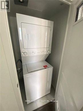 Richmond Hill (Langstaff) condo for rent - A white refrigerator with a freezer drawer is shown in a small space.