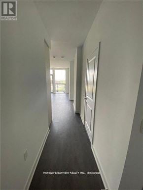 Richmond Hill (Langstaff) condo for rent - A long hallway with white walls and a black floor.