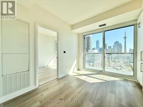 Toronto (Kensington-Chinatown) condo for rent - A room with a view of the city skyline through the windows.