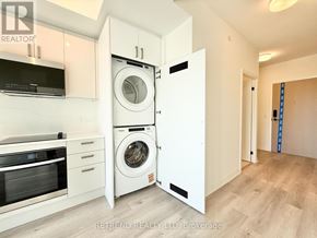 Toronto (Kensington-Chinatown) condo for rent - A white laundry room with a washer and dryer in it.