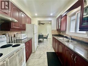 Cambridge apartment for rent - A kitchen with dark wood cabinets and a white stove top oven.