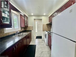 Cambridge apartment for rent - A kitchen with a white refrigerator and dark brown cabinets.