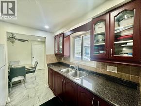Cambridge apartment for rent - A kitchen with brown cabinets and a sink.