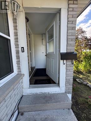 Oshawa (Vanier) apartment for rent - A white door is open to a hallway.