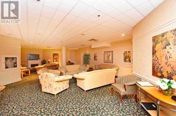 Brampton (Goreway Drive Corridor) condo for rent - A living room with a carpet and a painting on the wall.