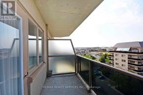 Brampton (Goreway Drive Corridor) condo for rent - A balcony with a glass door and a view of the city.