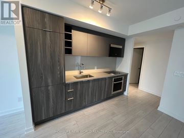 Toronto (Agincourt South-Malvern West) condo for rent - A modern kitchen with dark wood cabinets and a white sink.