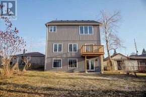 Ramara (Brechin) apartment for rent - A grey house with a brown deck in the foreground.