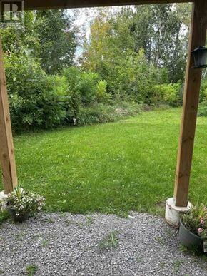 Ramara (Brechin) apartment for rent - A garden with a gravel path and a wooden pergola.