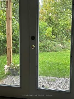 Ramara (Brechin) apartment for rent - A glass door with a handle and a lock is open.