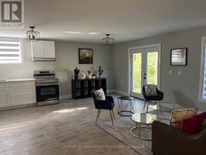 Ramara (Brechin) apartment for rent - A modern living room with a kitchen area in the background.