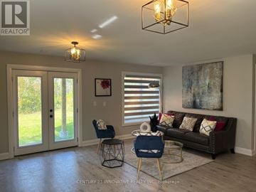 Ramara (Brechin) apartment for rent - A living room with a couch, chair, and a painting on the wall.