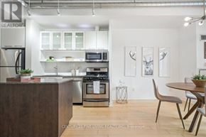 Toronto (Waterfront Communities) condo for rent - A modern kitchen with a wooden island and stainless steel appliances.