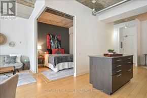 Toronto (Waterfront Communities) condo for rent - A bedroom with a bed, a couch, a chair, and a cabinet.
