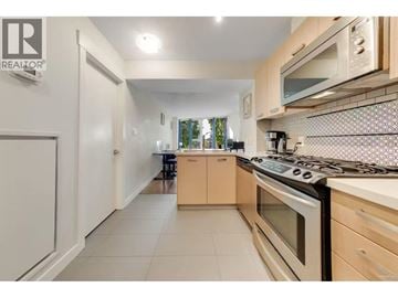 Richmond apartment for rent - A kitchen with a stove top oven and a microwave above it.