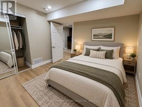 Guelph (Kortright West) apartment for rent - A bedroom with a large bed and a wardrobe.