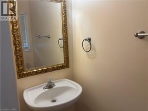Stoney Creek townhouse for rent - A bathroom with a sink, mirror and towel rack.