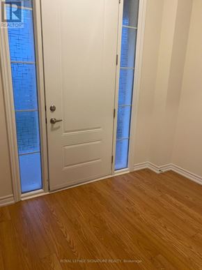 Erin apartment for rent - A white door with a glass panel and a wooden floor.