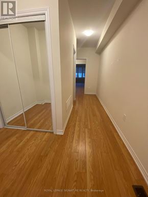Erin apartment for rent - A hallway with wood flooring and white walls.