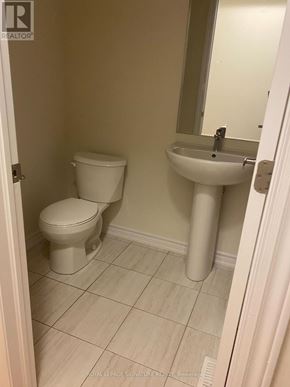 Erin apartment for rent - A bathroom with a toilet, sink and mirror.