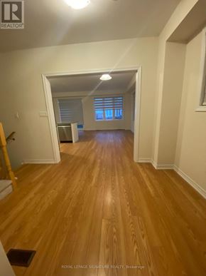 Erin apartment for rent - A room with wooden flooring and white walls.