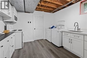 Kitchener apartment for rent - A kitchen with white cabinets and a wooden floor.