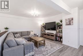 Alfred And Plantagenet multi-family for rent - A living room with a grey sofa and a wooden coffee table.