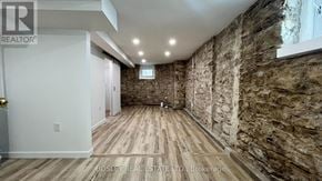 Toronto (High Park North) apartment for rent - A room with wooden floors and stone walls.