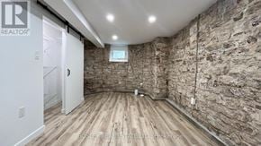 Toronto (High Park North) apartment for rent - A room with wooden floors and stone walls.