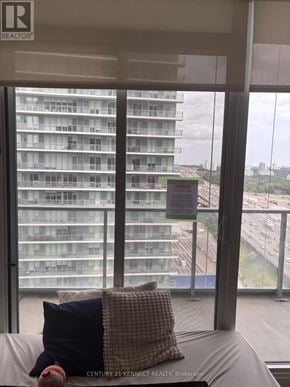 Toronto (Bayview Village) condo for rent - A window with a view of a highway and a building across the street.