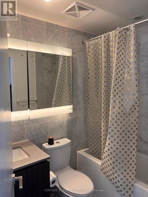 Toronto (Bayview Village) condo for rent - A bathroom with a toilet, sink, and shower curtain.
