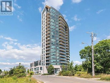 Toronto (Leaside) condo for rent - A tall, modern building with a curved facade and balconies on the upper floors.
