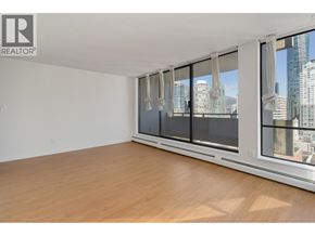 Vancouver apartment for rent - A room with a large window and wooden flooring.