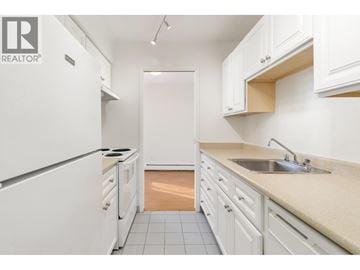 Vancouver apartment for rent - A kitchen with white cabinets and appliances.