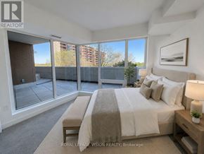 Toronto (Humber Heights) condo for rent - A bedroom with a large bed and a view of the outside.